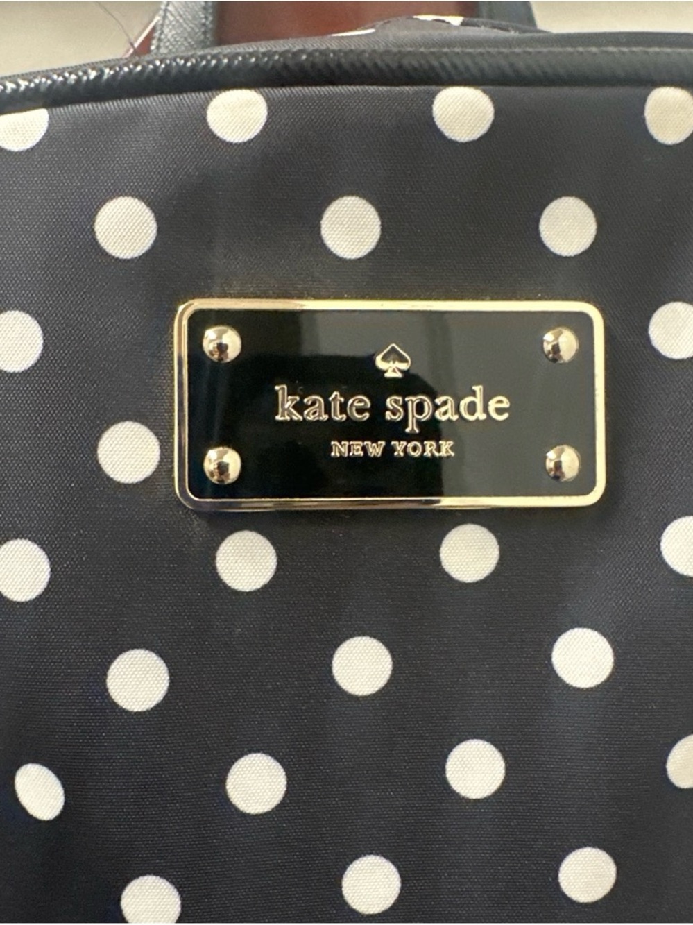 kate spade Black and White Polka Dot Backpack with Gold Plaque